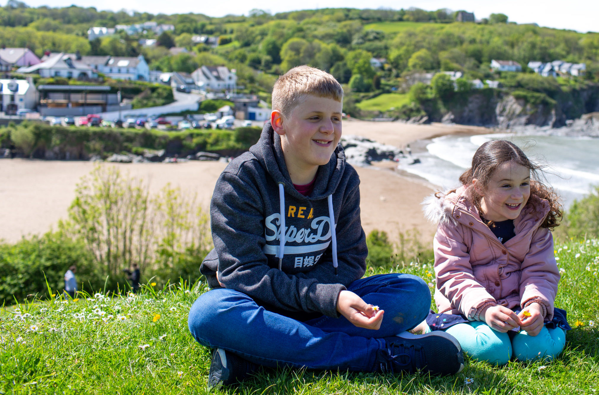 Boy and girl at top of cliffs smiling